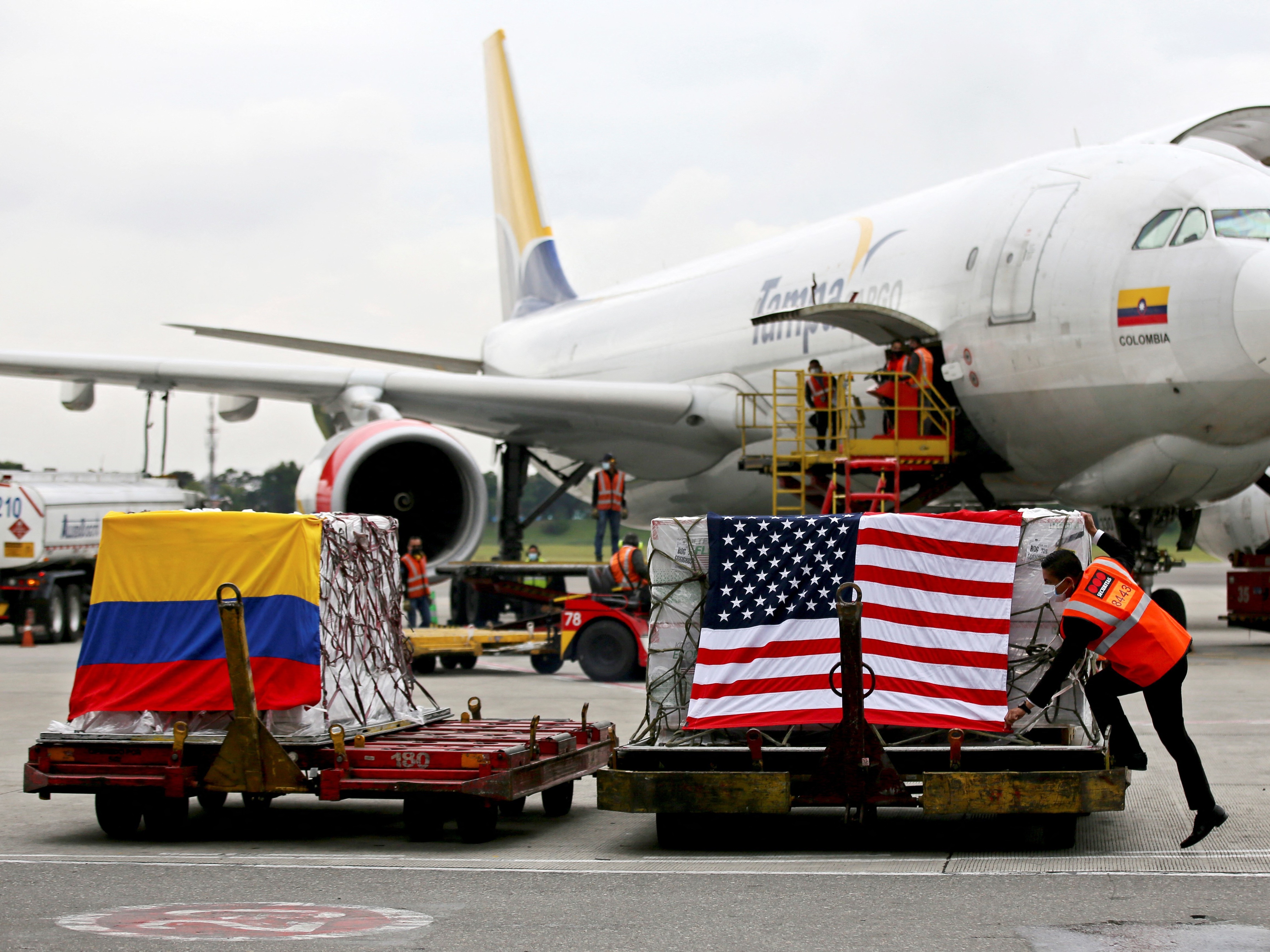 caption: Containers of Moderna COVID-19 vaccine doses, donated by the United States, arrive in Bogota, Colombia, in July. The U.S. plans to send more than a billion vaccines abroad by September 2022.