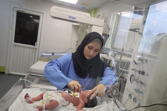 caption: This newborn at Gaza's Nasser Hospital was delivered after their mother was killed in an Israeli airstrike on Oct. 24. The doctor said the baby is now in stable condition.