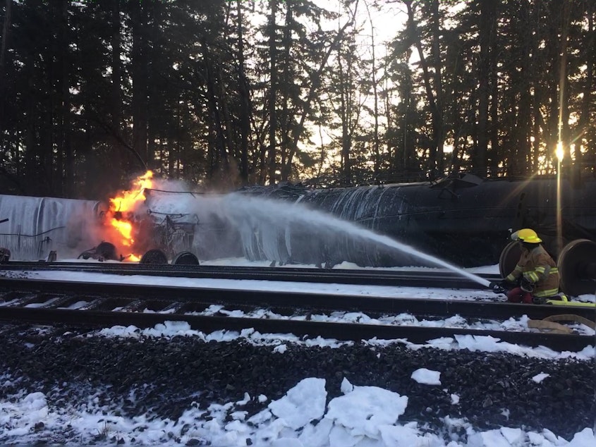 caption: A firefighter attacks a burning oil train in Custer, Washington, on Dec. 22, 2020.