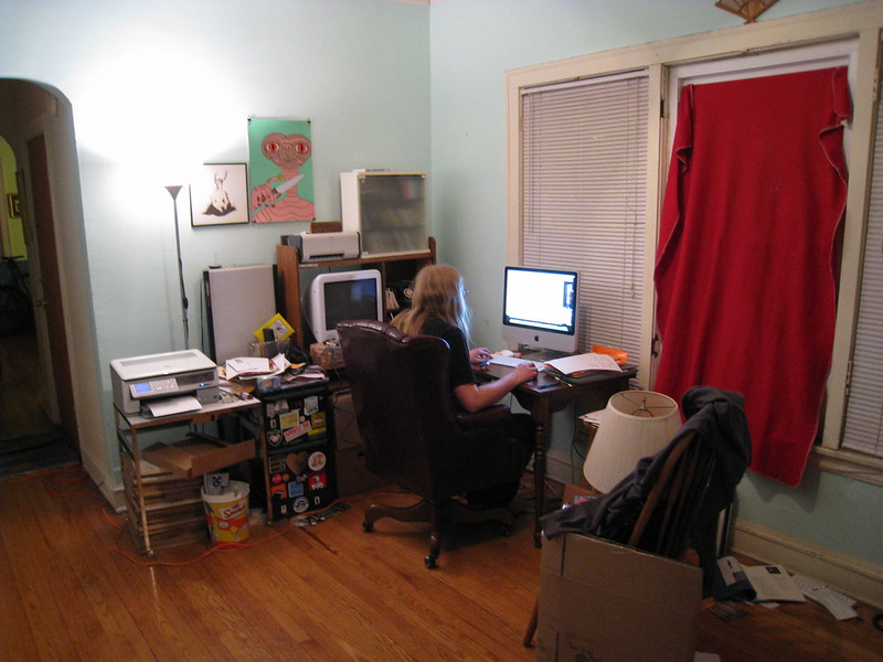 caption: Person working on their home computer.