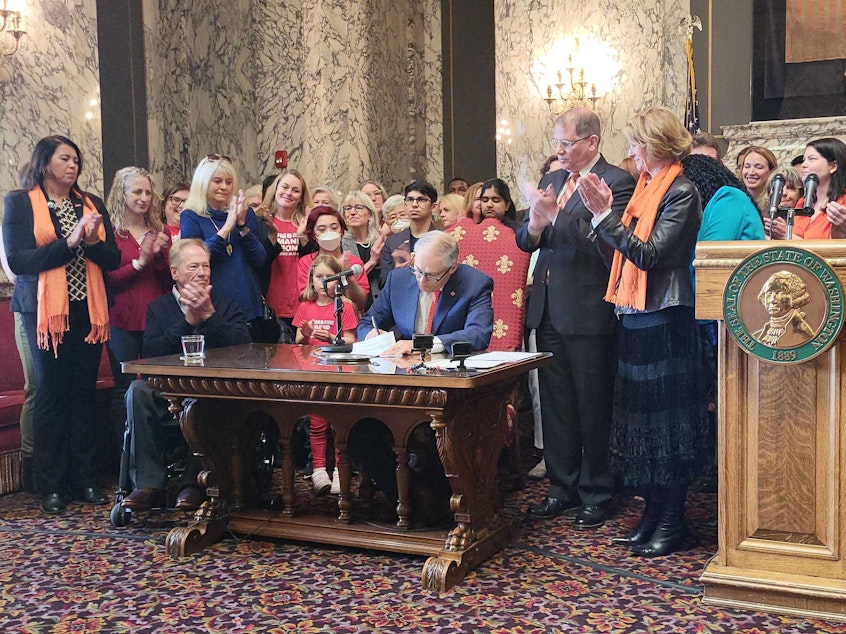 caption:  Washington Gov. Jay Inslee signed three new gun bills into law Tuesday, including an assault weapons ban that takes immediate effect. 