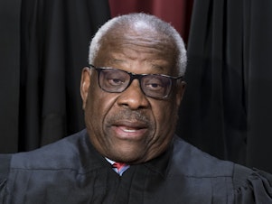 caption: Justice Clarence Thomas poses for a photo at the Supreme Court building in Washington on Oct. 7, 2022. Thomas told attendees at a judicial conference Friday that he and his wife have faced "nastiness and lies" over the last several years. He also decried Washington, D.C., as a "hideous place."