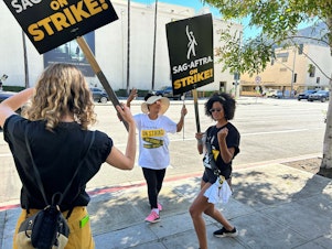 caption: Actress Gabrielle Maiden and fellow SAG-AFTRA members picket outside Universal Studios.