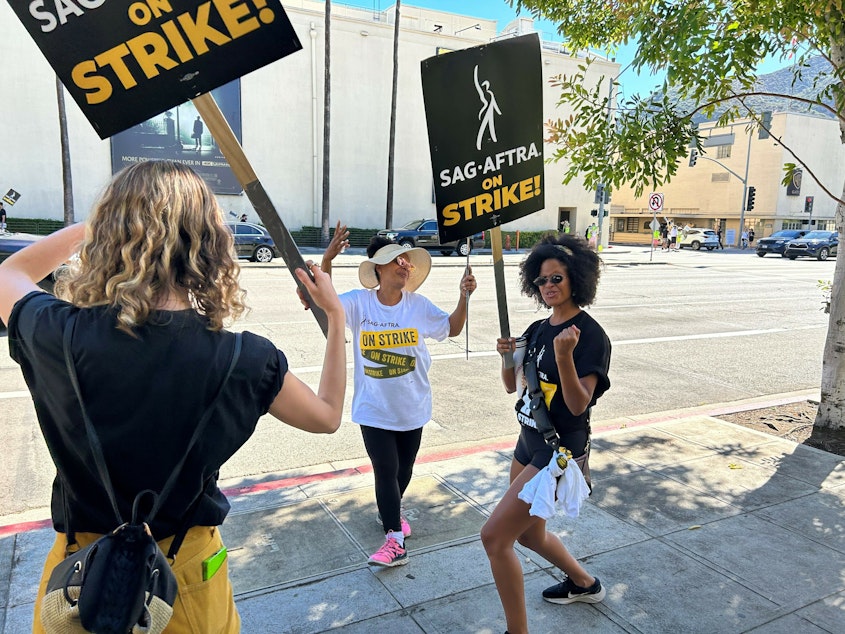 caption: Actress Gabrielle Maiden and fellow SAG-AFTRA members picket outside Universal Studios.