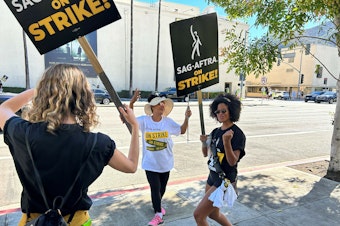caption: Actress Gabrielle Maiden and fellow SAG-AFTRA members picket outside Universal Studios.