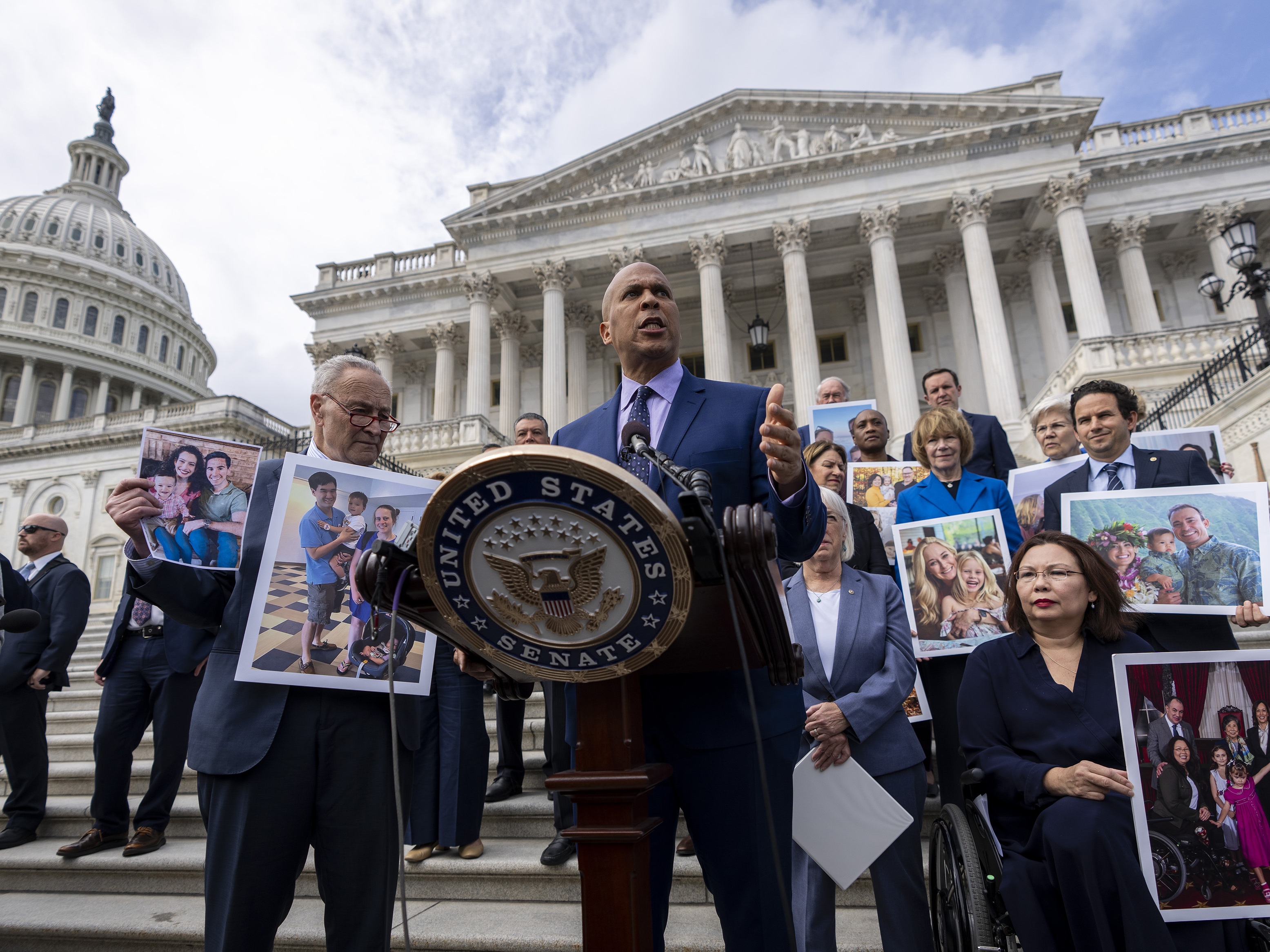 caption: Sen. Cory Booker, D-NJ., accompanied by Senate Majority Leader Chuck Schumer, D-NY, left, and Sen. Tammy Duckworth, D-Ill., right, speaks about the need to protect rights to in vitro fertilization (IVF), before Senate vote on the issue.