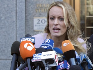 caption: Adult film actress Stormy Daniels speaks outside federal court in New York in April 2018. She is testifying this week in the criminal trial of former President Donald Trump.