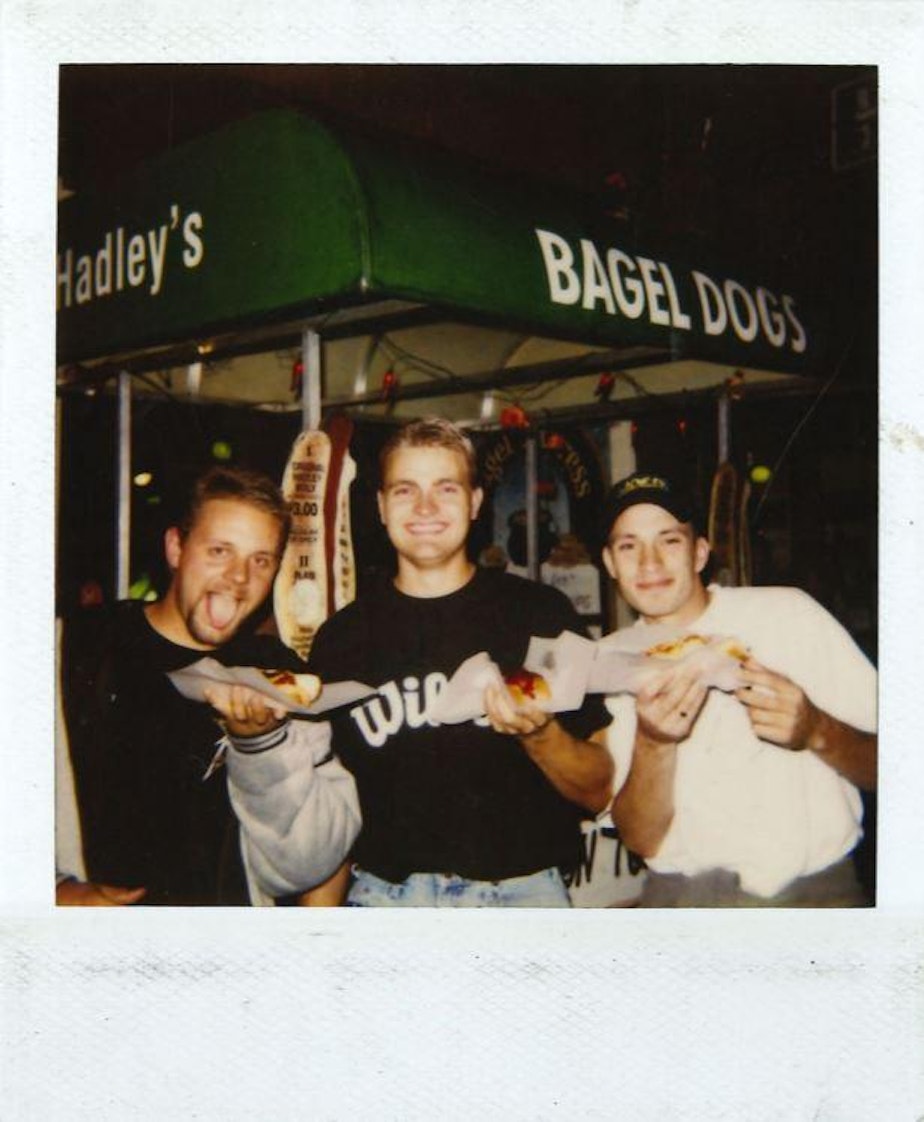 caption: 1980s Seattle, maybe 1990s, Polaroid photo outside the Bagel Dogs pushcart. Regulars would return to see if the Polaroid photo taken of them the week before had been posted.