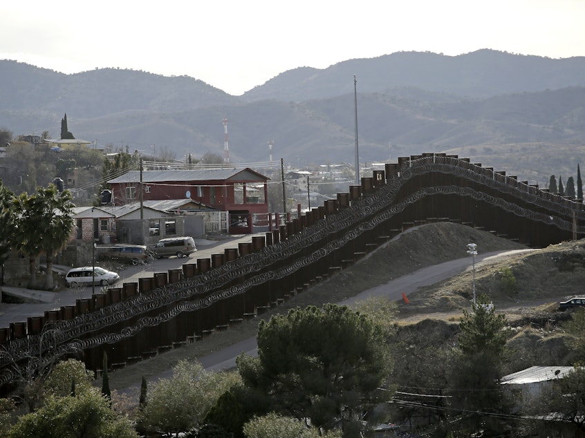 caption: The president declared a national emergency in February to access federal money to build a wall similar to this razor-wire-covered border wall separating Nogalas, Mexico (left), and Nogales, Ariz. Congress did not approve the full amount he asked for last year to follow through on a key campaign pledge.