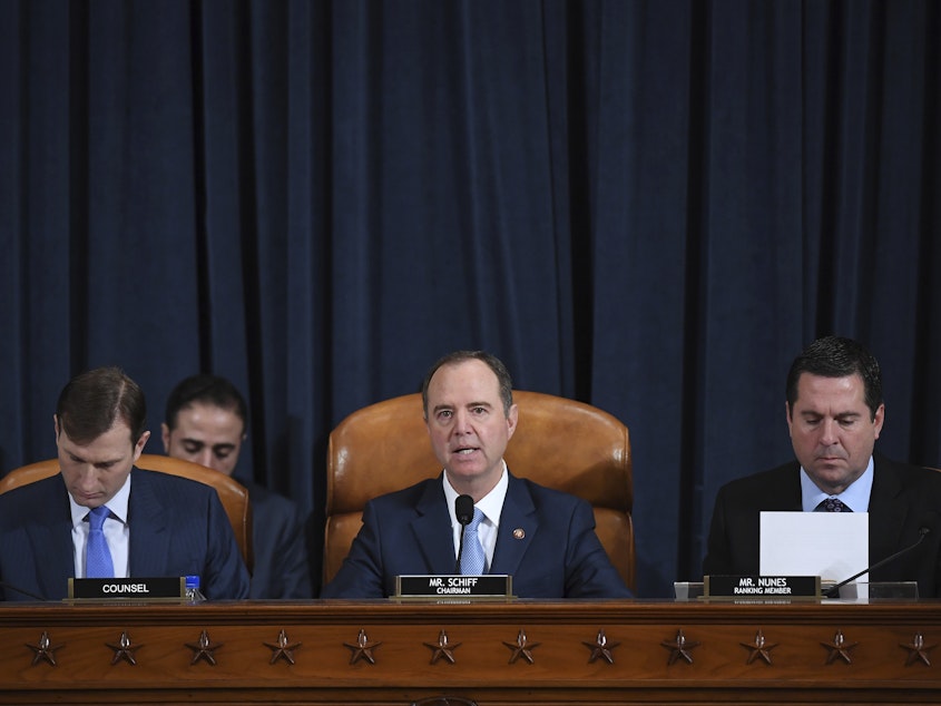 caption: House Intelligence Committee Chairman Adam Schiff, D-Calif. (center); ranking member Rep. Devin Nunes of California (right); and committee counsel Daniel Goldman hold an impeachment inquiry hearing on Nov. 21. Schiff has released the panel's report on the inquiry.