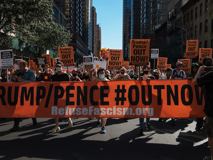caption: People march during the nationwide protest demanding the end to the Trump administration in New York City on Saturday. Protesters have often accused President Trump of being fascist.