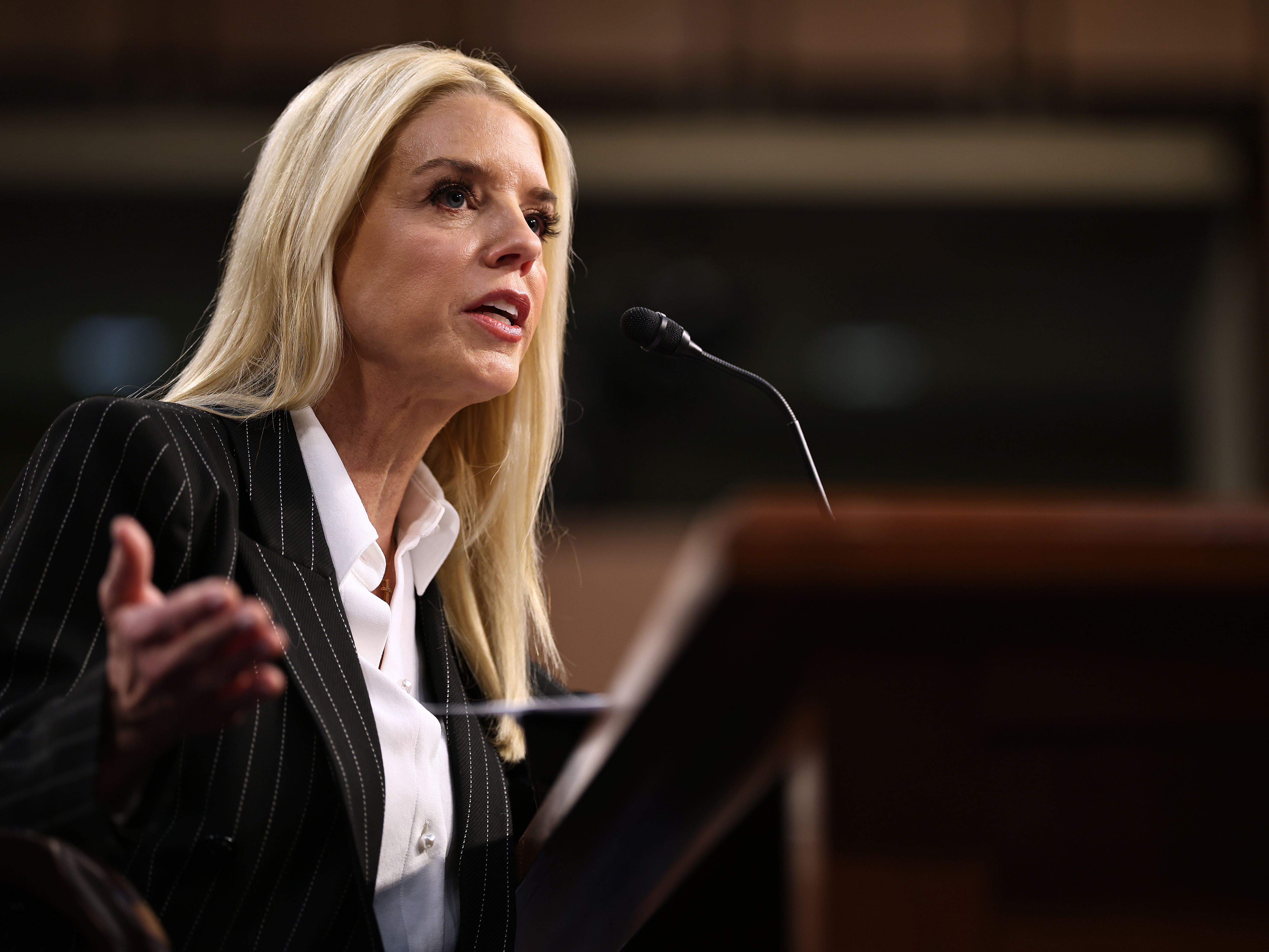 caption: Pam Bondi testifies before the Senate Judiciary Committee on Jan. 15 during her confirmation hearing to be the next U.S. attorney general.