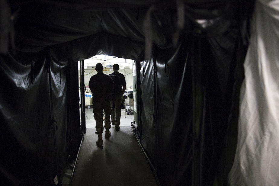 caption: A tunnel into the operating suite is shown at the military field hospital inside CenturyLink Field Event Center on Sunday, April 5, 2020, in Seattle. The 250-bed hospital for non COVID-19 patients was deployed by U.S. Army soldiers from the 627th Army Hospital from Fort Carson, Colorado, as well as soldiers from Joint Base Lewis-McChord.