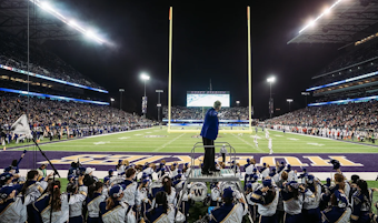 caption: Dr. Brad McDavid, director of the Husky Marching Band, during a performance at Husky Stadium. 