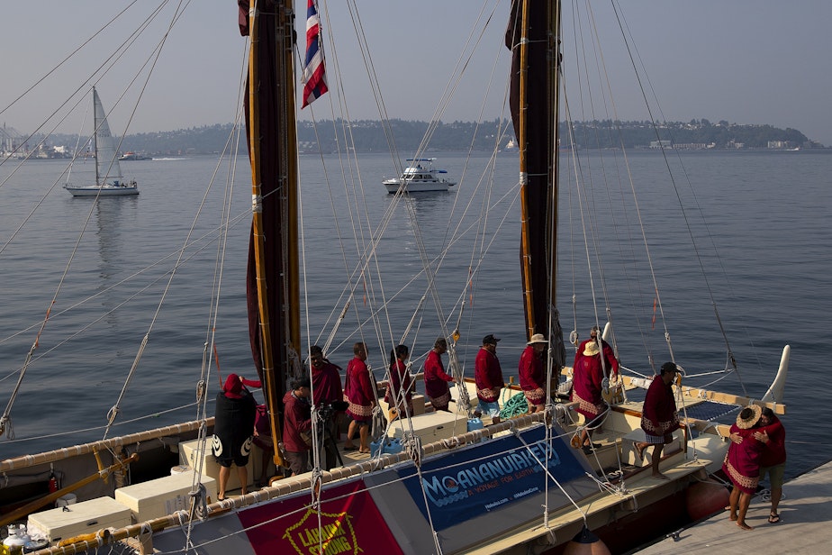 caption: The crew of Hokule’a, the 49-year-old replica of an ancient Polynesian voyaging canoe, arrives at Pier 62, after a water welcome ceremony with Suquamish, Muckleshoot and Hawaiian canoes, on Saturday, August 26, 2023, in Seattle. 