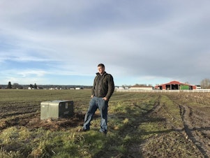 caption: Third-generation Arlington farmer Andrew Albert. Albert planted winter wheat around a power box that was meant to serve the housing development.