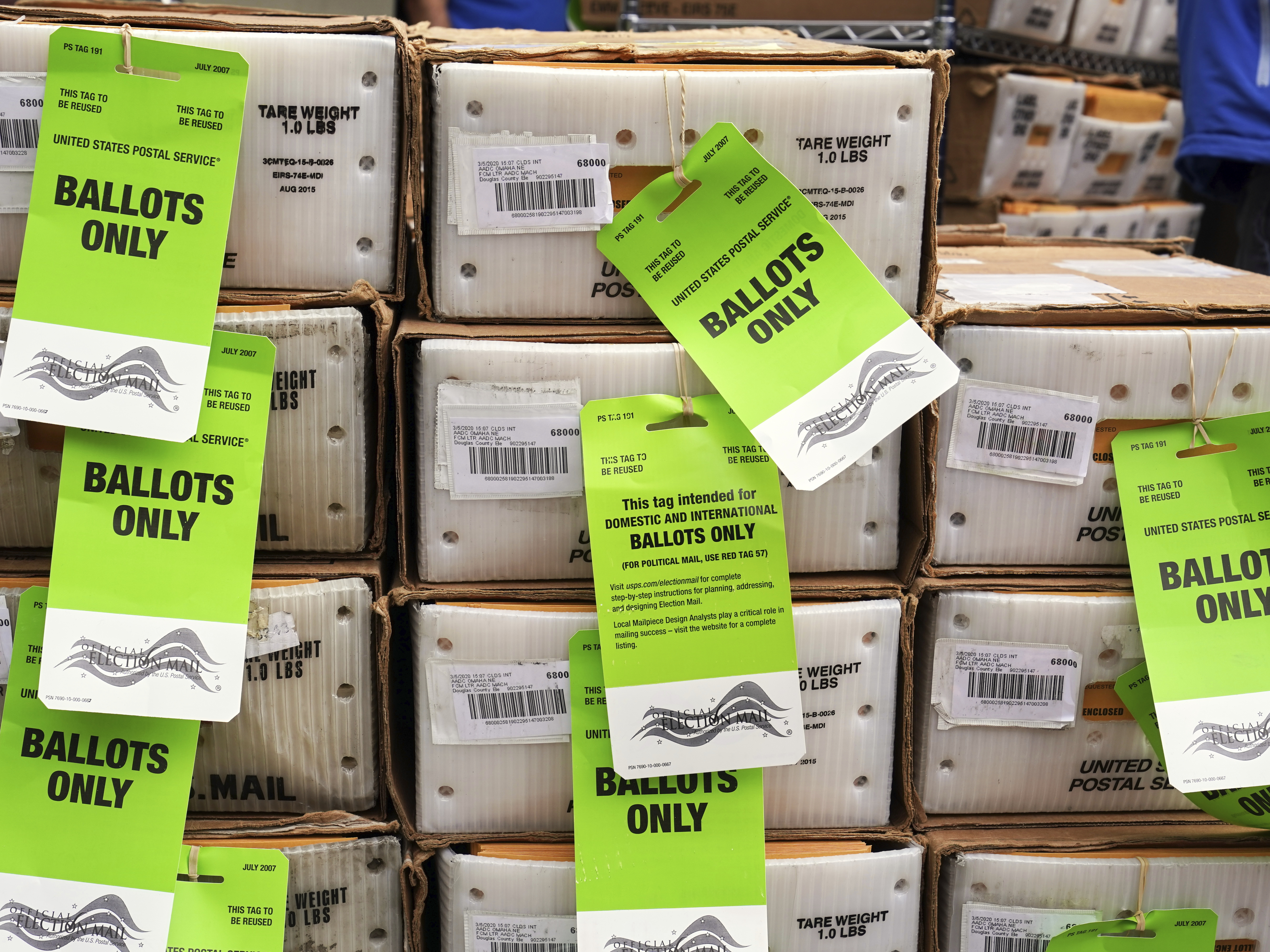 caption: Some 4 in 10 voters are expected to cast their ballots by mail this year, according to one survey.