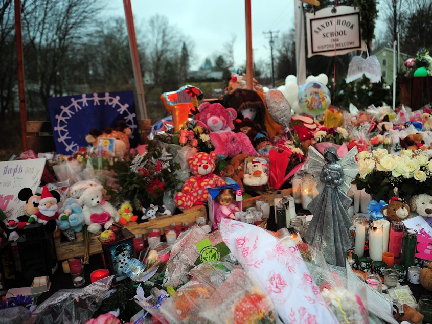 caption: A makeshift shrine to the victims of the Sandy Hook Elementary school shooting is set up shortly after the massacre in December 2012 in Newtown, Conn.