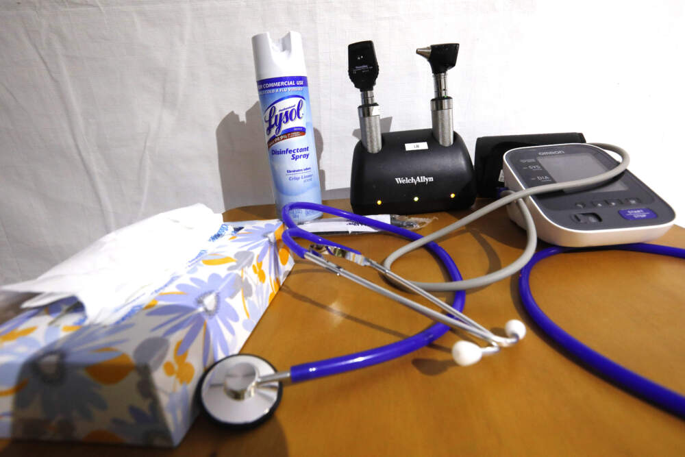caption: A stethoscopes and blood pressure monitor on set on a rolling rolling table. (Rogelio V. Solis/AP)