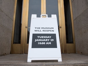 caption: A sign at the entrance of the Smithsonian National Museum of Natural History in Washington, D.C., says the museum will reopen Tuesday. The shutdown reduced federal spending by $18 billion, although most of that will be recouped now that the government has reopened, according to a new report.