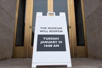 caption: A sign at the entrance of the Smithsonian National Museum of Natural History in Washington, D.C., says the museum will reopen Tuesday. The shutdown reduced federal spending by $18 billion, although most of that will be recouped now that the government has reopened, according to a new report.
