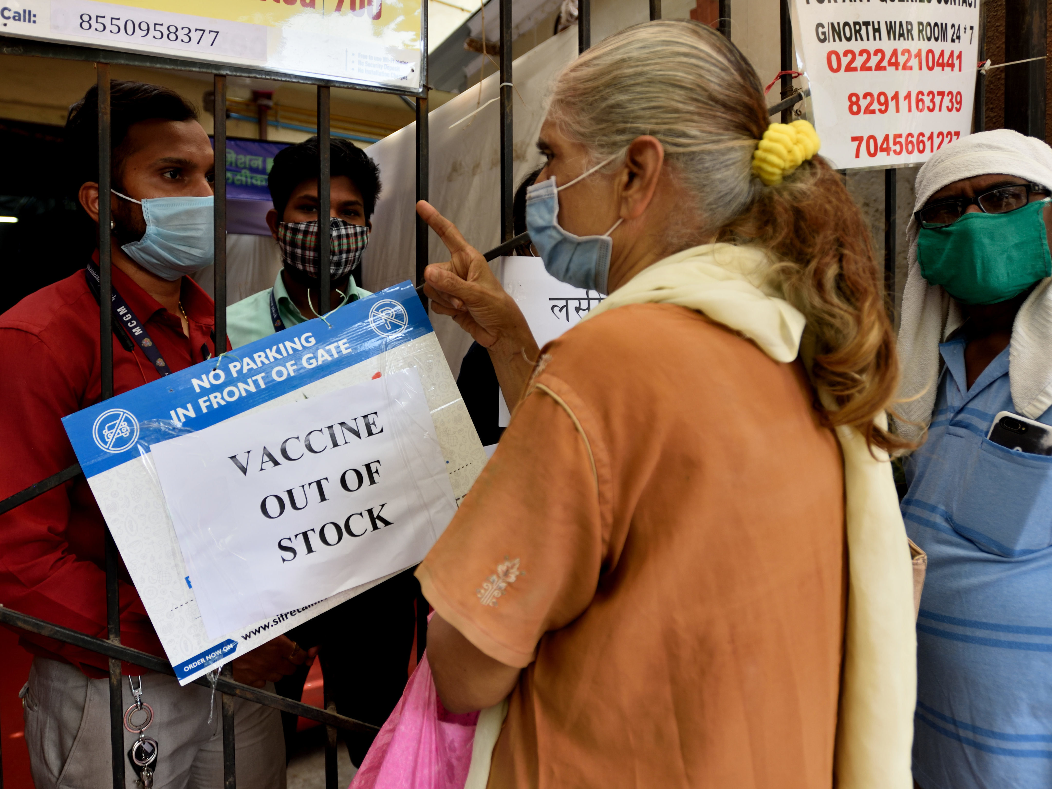 caption: A public notice hangs outside a vaccination center notifying of  vaccine shortages, in Mahim, in Mumbai, India, on Thursday.