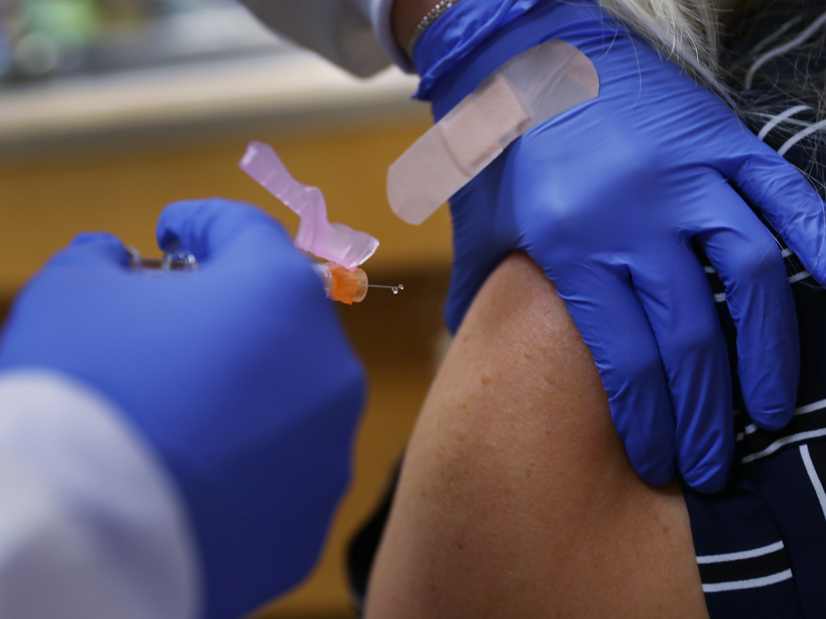 caption: Some of the world's largest vaccine-makers hope to bolster public confidence in a yet-to-arrive COVID-19 vaccine, pledging to follow strict safety protocols in the rush to respond to the pandemic. Here, a nurse practitioner administers a dose of flu vaccine in Key Biscayne, Fla.