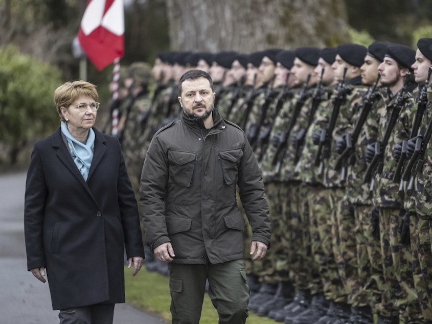 caption: Swiss Federal President Viola Amherd, left, and her guest, Volodymyr Zelenskyy, right, President of Ukraine, inspect the guard of honour in Kehrsatz near Bern, Switzerland, Monday, Jan. 15, 2024.