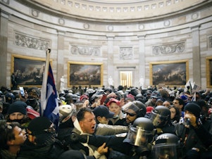 caption: Police clash with supporters of President Donald Trump who breached security and entered the Capitol building in Washington D.C., on Jan. 6, 2021.
