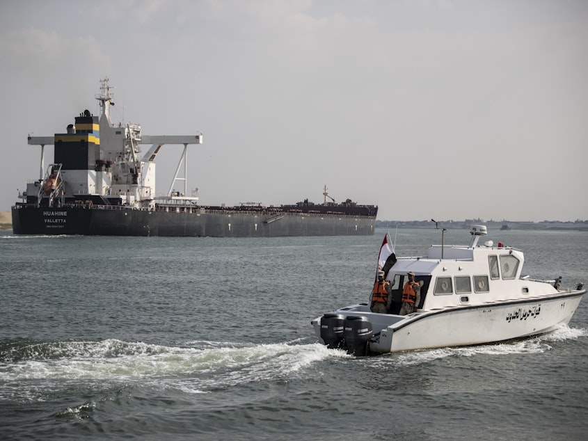 caption: Traffic through the Suez Canal has returned to normal, the canal authority says. Here, the Huahine is seen crossing the canal on March 30 in Ismailia, Egypt.