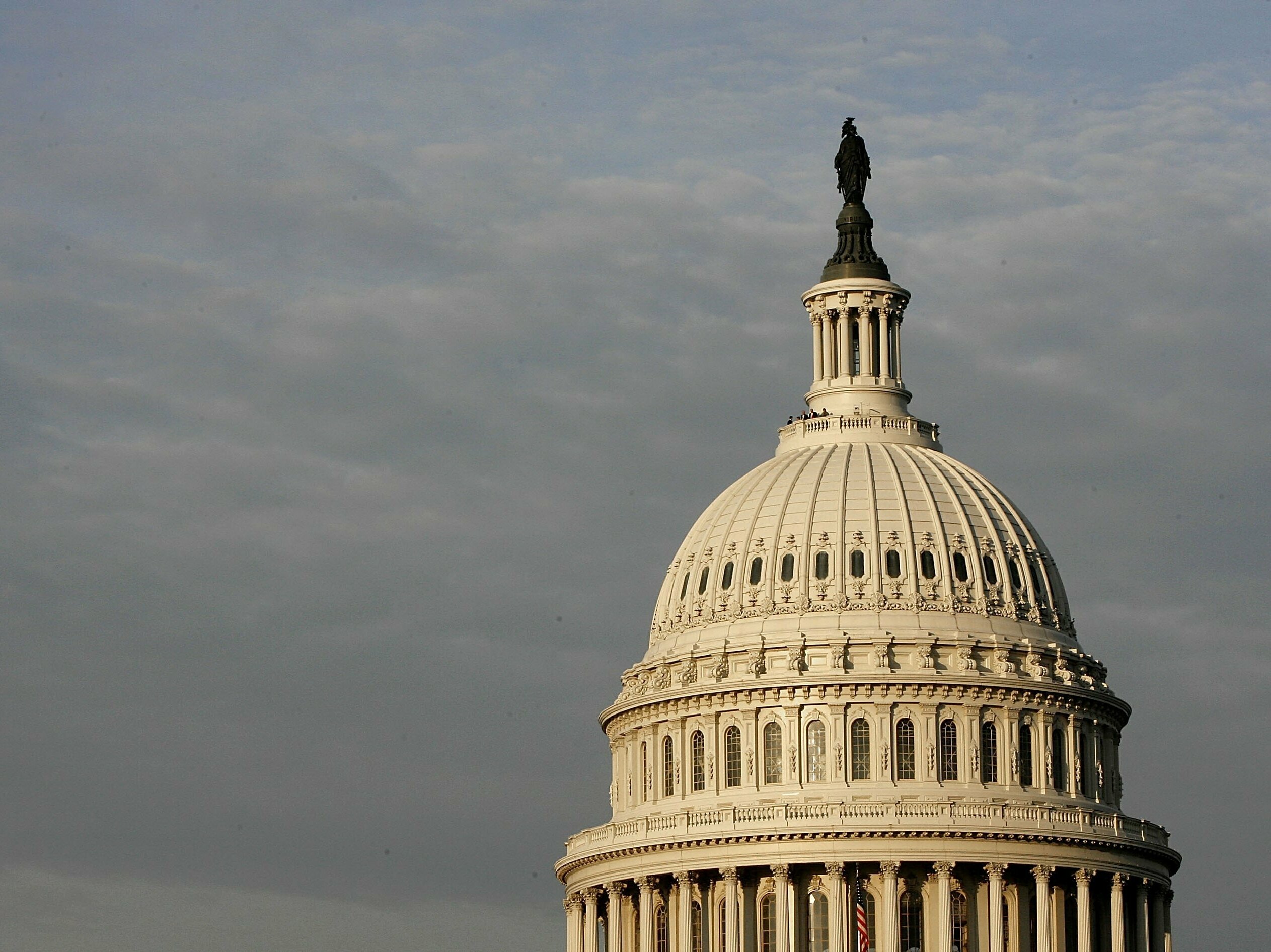 caption: Fitch cut the United States' rating by one notch, moving it from the previous top-rated AAA to AA+, just two months after the government avoided a devastating default.