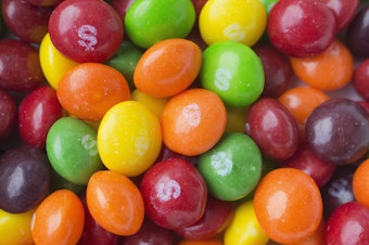caption: A lawsuit against Mars, the company that makes Skittles, points to titanium dioxide in the candy. The ingredient is one of thousands of additives allowed in foods under federal regulations.