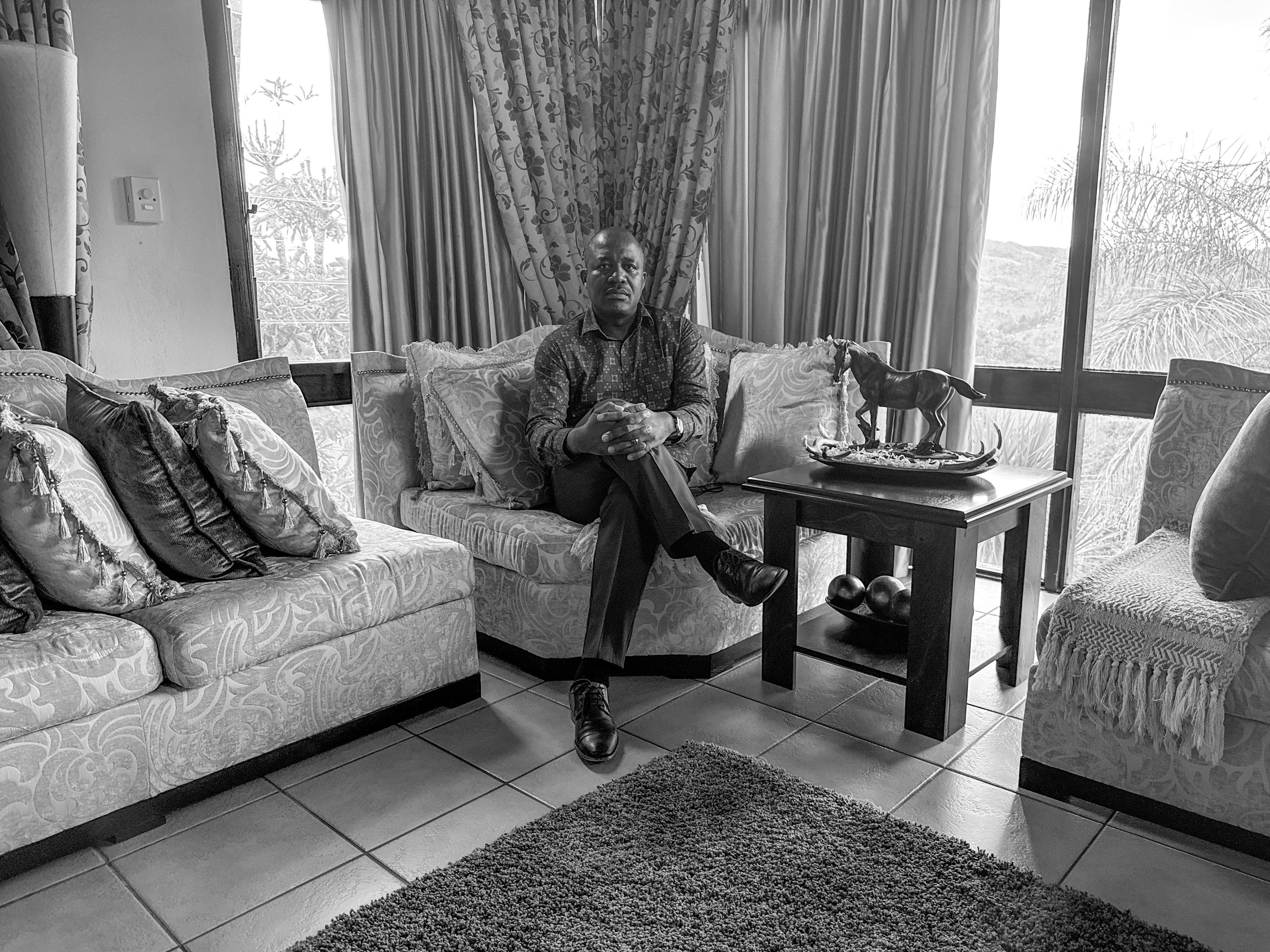 caption: Dr. Caspian Chouraya in his home in Mbabane, Eswatini, says U.S. funding cuts have meant many of his projects have shut down, like support groups for teenagers with HIV.