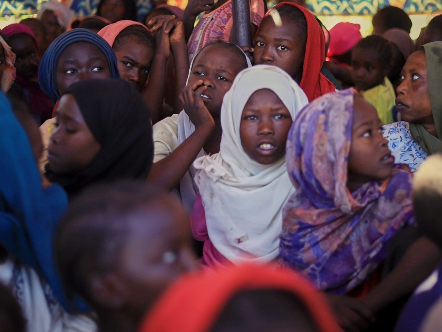caption: This photo released by The Norwegian Refugee Council, shows displaced women and children from el-Fasher on Nov. 3 at a camp in Tawilia, Darfur region, Sudan, where they sought refuge from fighting between government forces and the RSF.