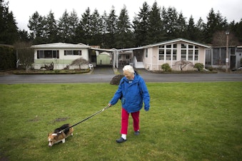 caption: Audrey Behrenhoff walks her dog Emma in front of her home in Redmond last week, at Friendly Village-55 Plus Park, recently purchased by King County Housing Authority. Behrenhoff, 80, has lived in three different mobile homes at Friendly Village.