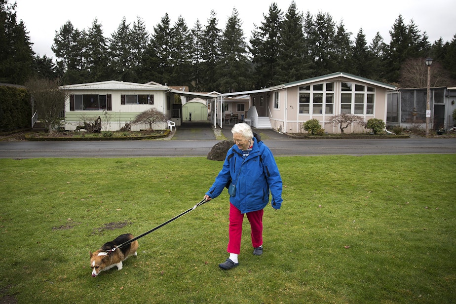caption: Audrey Behrenhoff walks her dog Emma in front of her home in Redmond last week, at Friendly Village-55 Plus Park, recently purchased by King County Housing Authority. Behrenhoff, 80, has lived in three different mobile homes at Friendly Village.