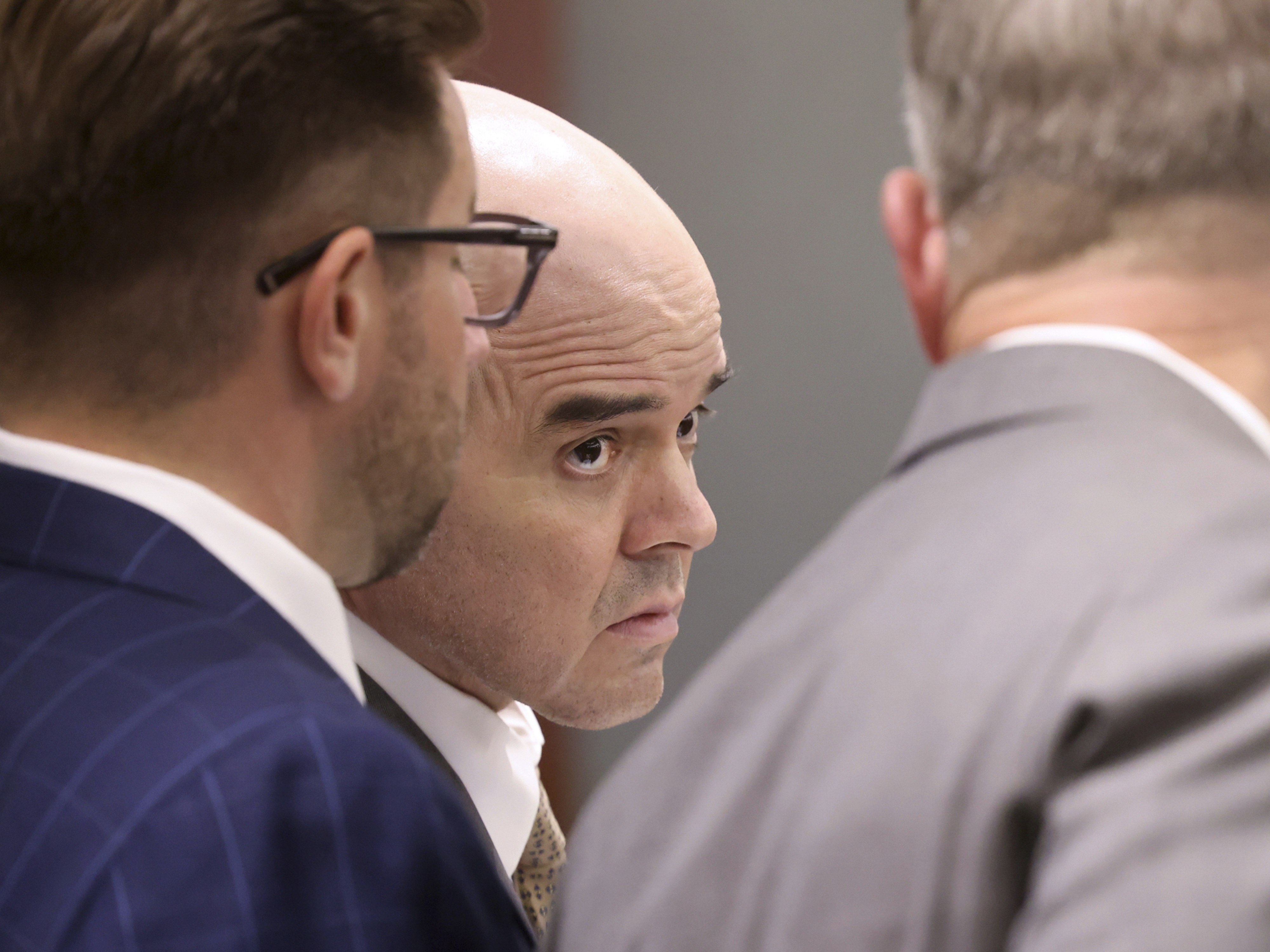 caption: Robert Telles, center, listens in court with his attorneys Robert Draskovich, right, and Michael Horvath, prior to jury selection on the second day of his murder trial at the Regional Justice Center in Las Vegas Tuesday, Aug. 13, 2024. Telles, a former Clark County public administrator, is charged in the murder of Las Vegas Review-Journal investigative journalist Jeff German. 