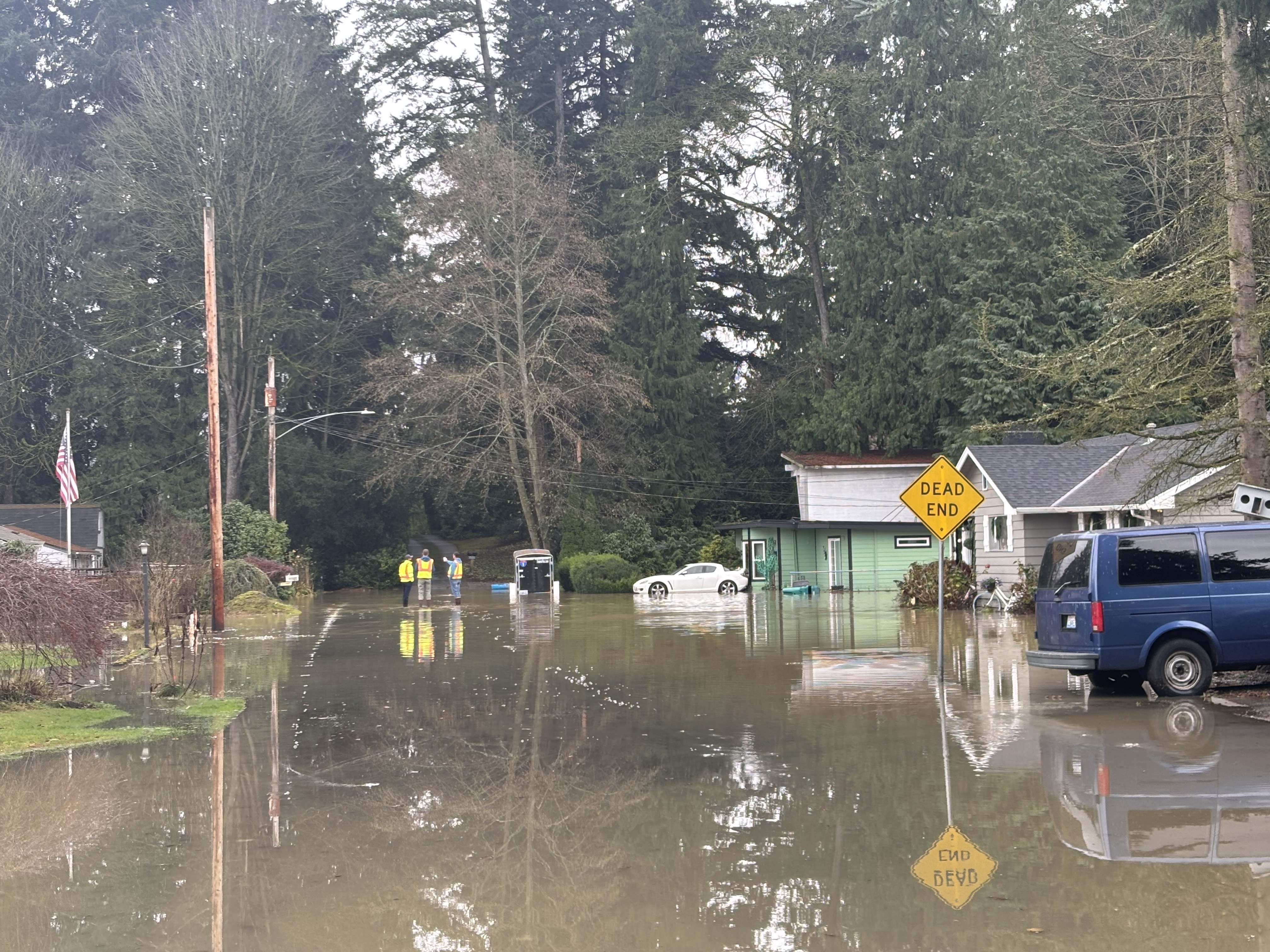 caption: Burlington Public Works employees assess flood damages in Burlington on Friday, Dec. 12.