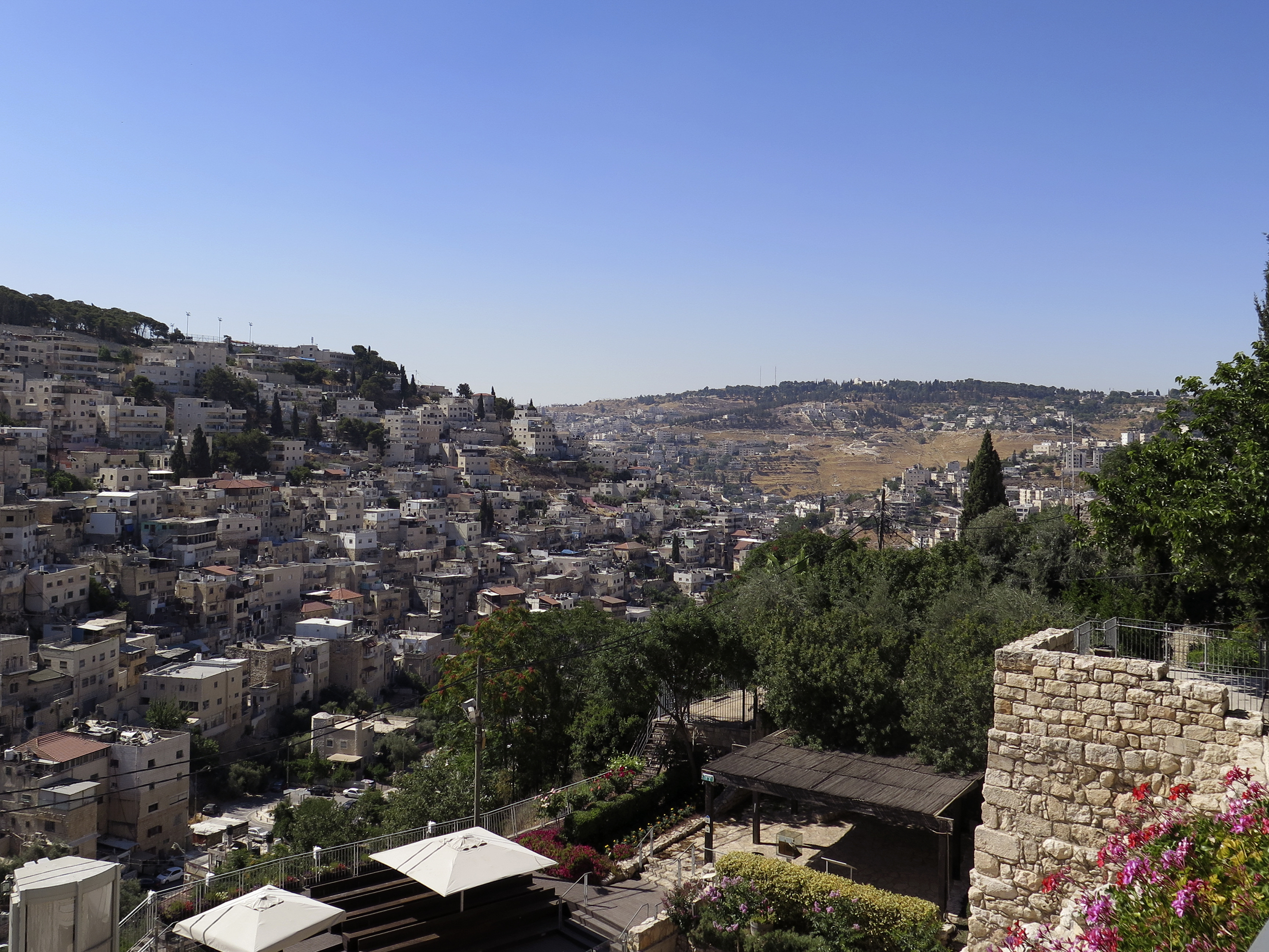caption: A view of the Silwan neighborhood from the City of David park, with the al-Bustan area at the bottom of the valley.