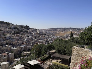 caption: A view of the Silwan neighborhood from the City of David park, with the al-Bustan area at the bottom of the valley.