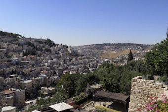 caption: A view of the Silwan neighborhood from the City of David park, with the al-Bustan area at the bottom of the valley.
