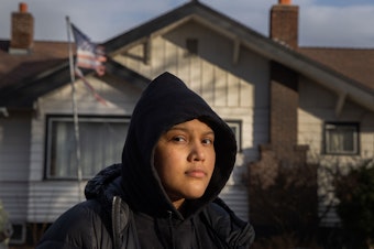 caption: Michelle Aguilar Ramirez recently moved to Spokane, Washington, from Seattle with her mom, but says she has struggled with the multiple racist incidents she's experienced since she's arrived. She walks in her neighborhood every day, but avoids certain areas where neighbors fly confederate flags or Make America Great Again signs.