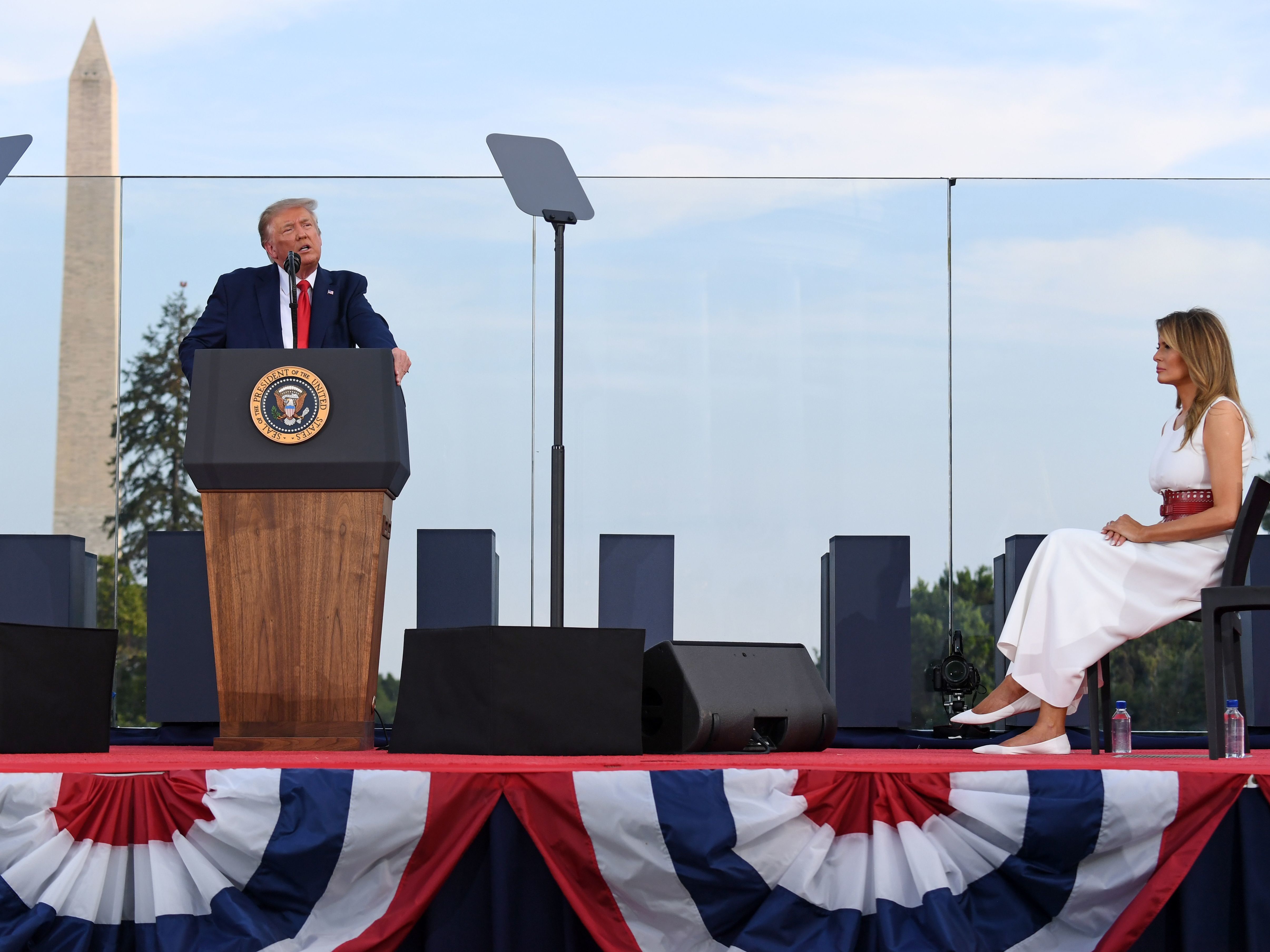 caption: President Trump speaks on the South Lawn of the White House, accompanied by First Lady Melania Trump, on July 4. He'll deliver his main convention speech from the same location on Thursday.