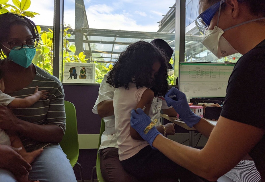 caption: Estella gets her first Covid-19 vaccine at a Seattle Children's clinic for children under five on June 21, 2022.
