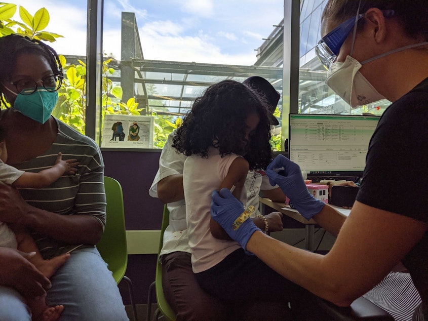 caption: Estella gets her first Covid-19 vaccine at a Seattle Children's clinic for children under five on June 21, 2022.