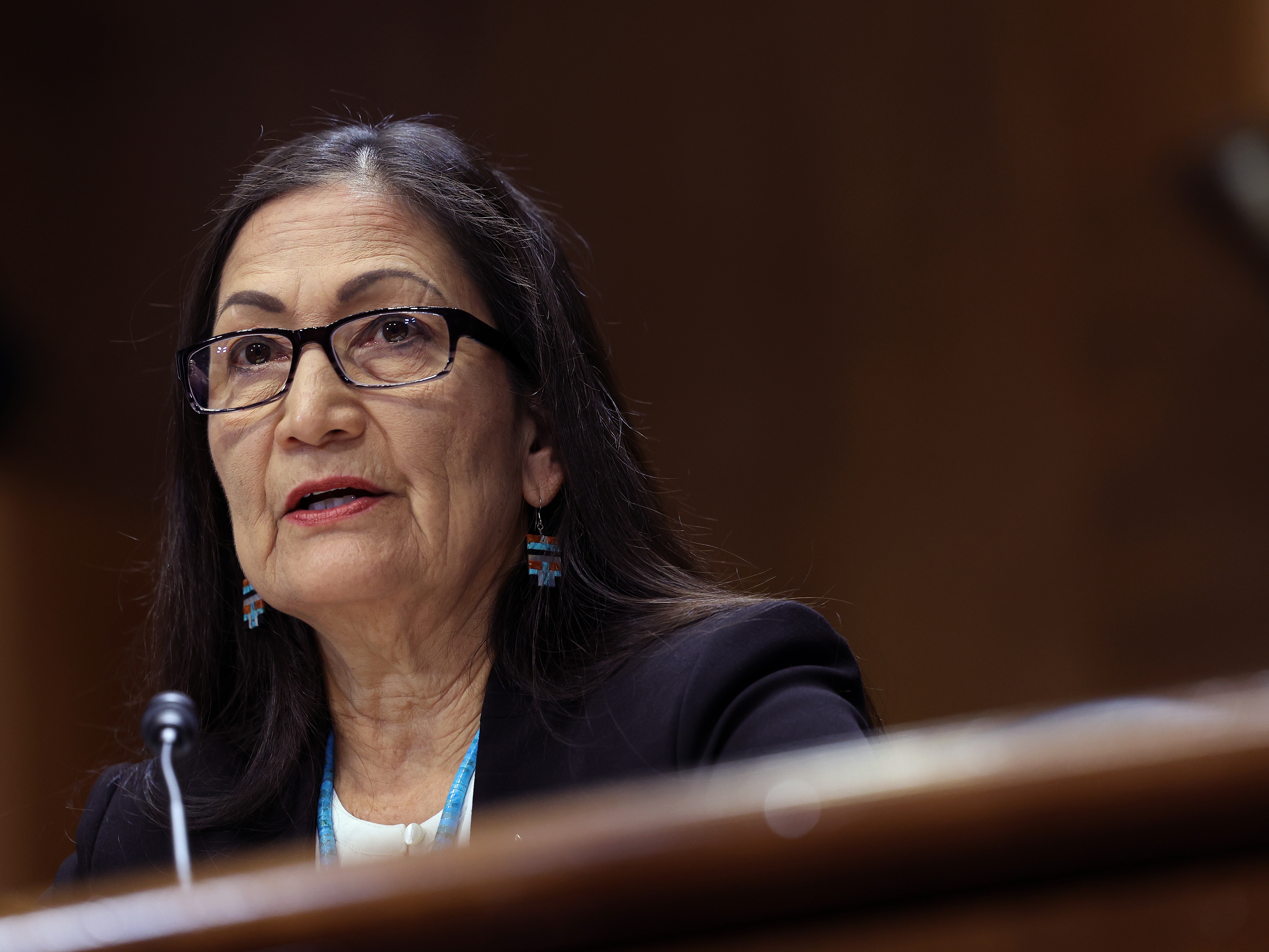 caption: U.S. Interior Secretary Deb Haaland testifies during a Senate Energy and Natural Resources hearing in May.
