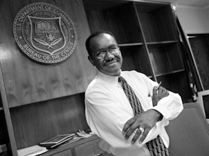 caption: James F. Holmes, the first-ever person of color to oversee the U.S. head count, stands inside his office at the Census Bureau's former headquarters in Suitland, Md., in 1998, when Holmes served as acting director for about nine months.