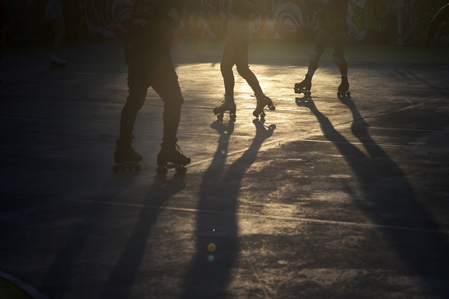 caption: People roller skate during a Roll Around Seatown skate meet up on Monday, September 28, 2020, at the Judkins Park sports courts in Seattle.