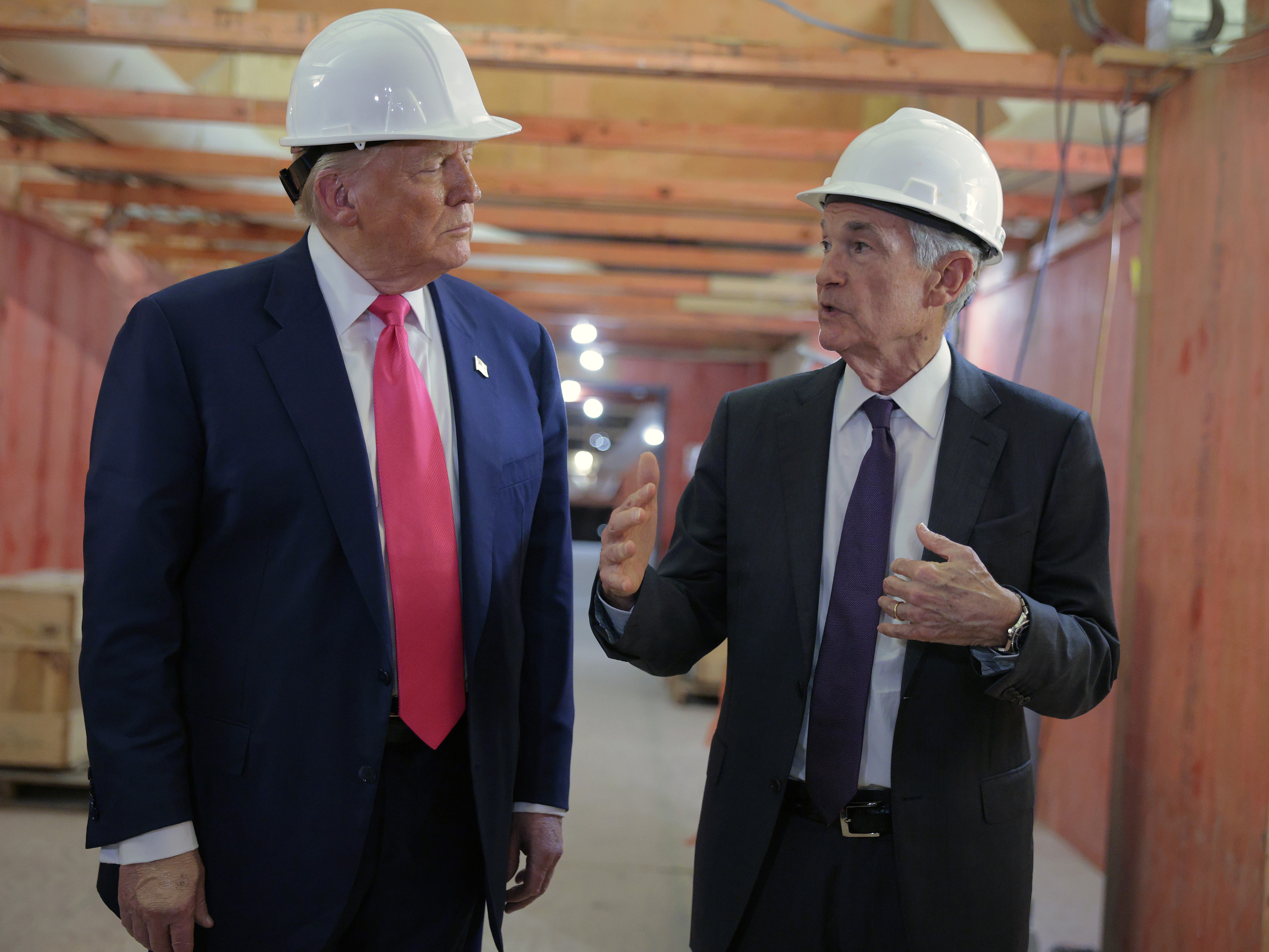 caption: President Trump accompanied Federal Reserve chairman Jerome Powell on a tour of the Fed's headquarters renovation last summer.  The Justice Department is investigating cost overruns on the project.