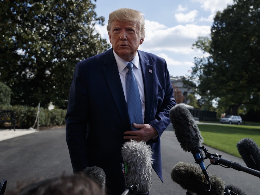 caption: President Trump talks to reporters on the South Lawn of the White House on Friday, demanding that the House formally vote on an impeachment inquiry before responding to lawmakers' requests for documents.